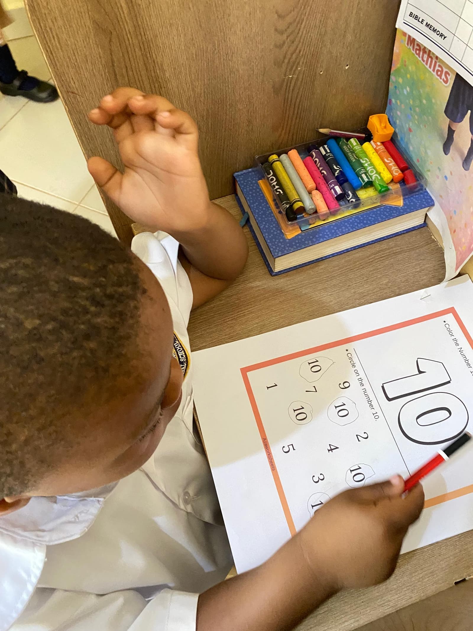 Students engaged in learning at Ariguma ACE