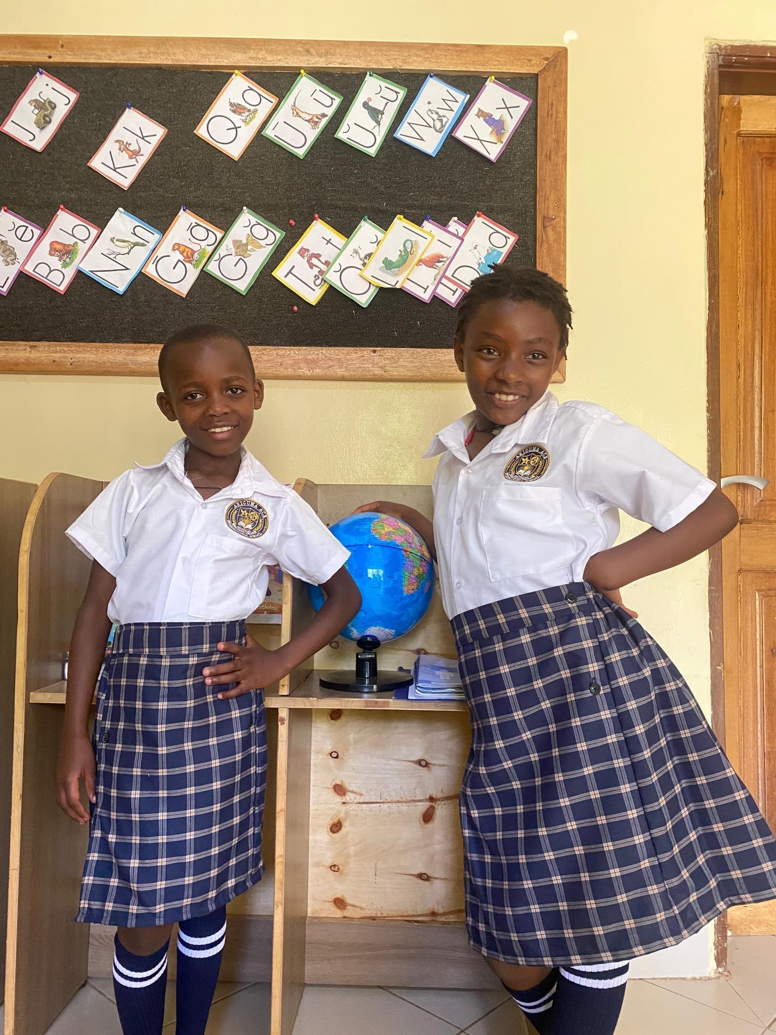 Learners exploring a globe together in class