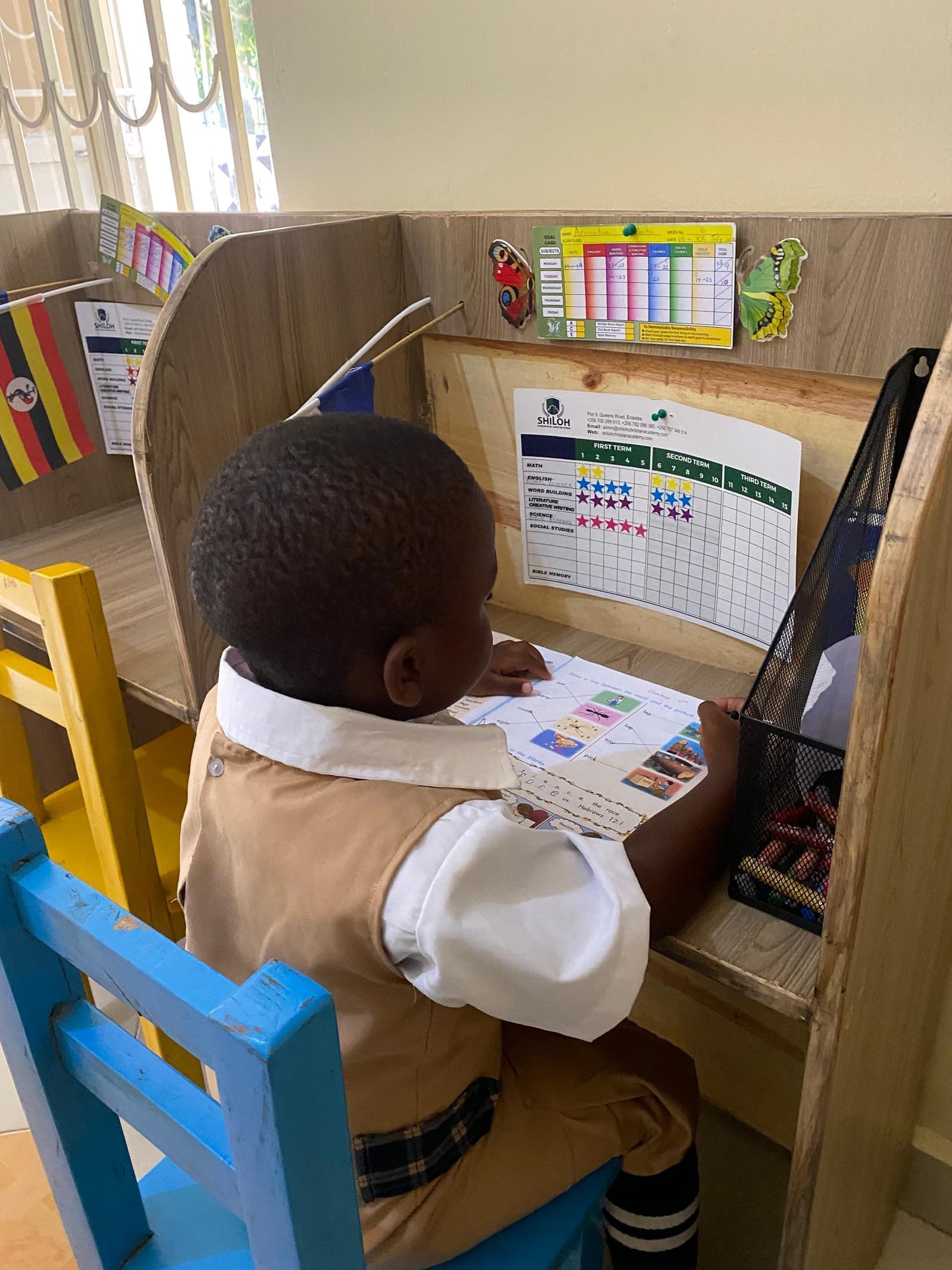 Learner studying beside the Christian flag at a study carrel